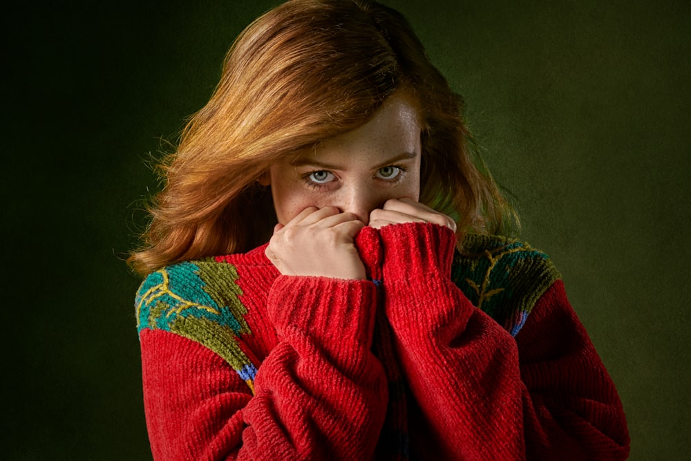 woman covering mouth with sweater