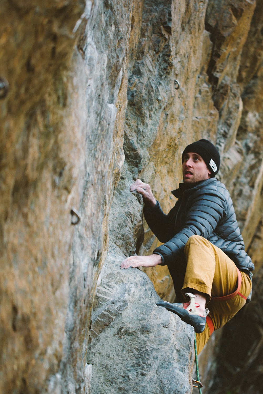 a man climbing up the side of a mountain