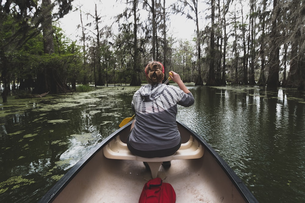 woman rowing boat on lake