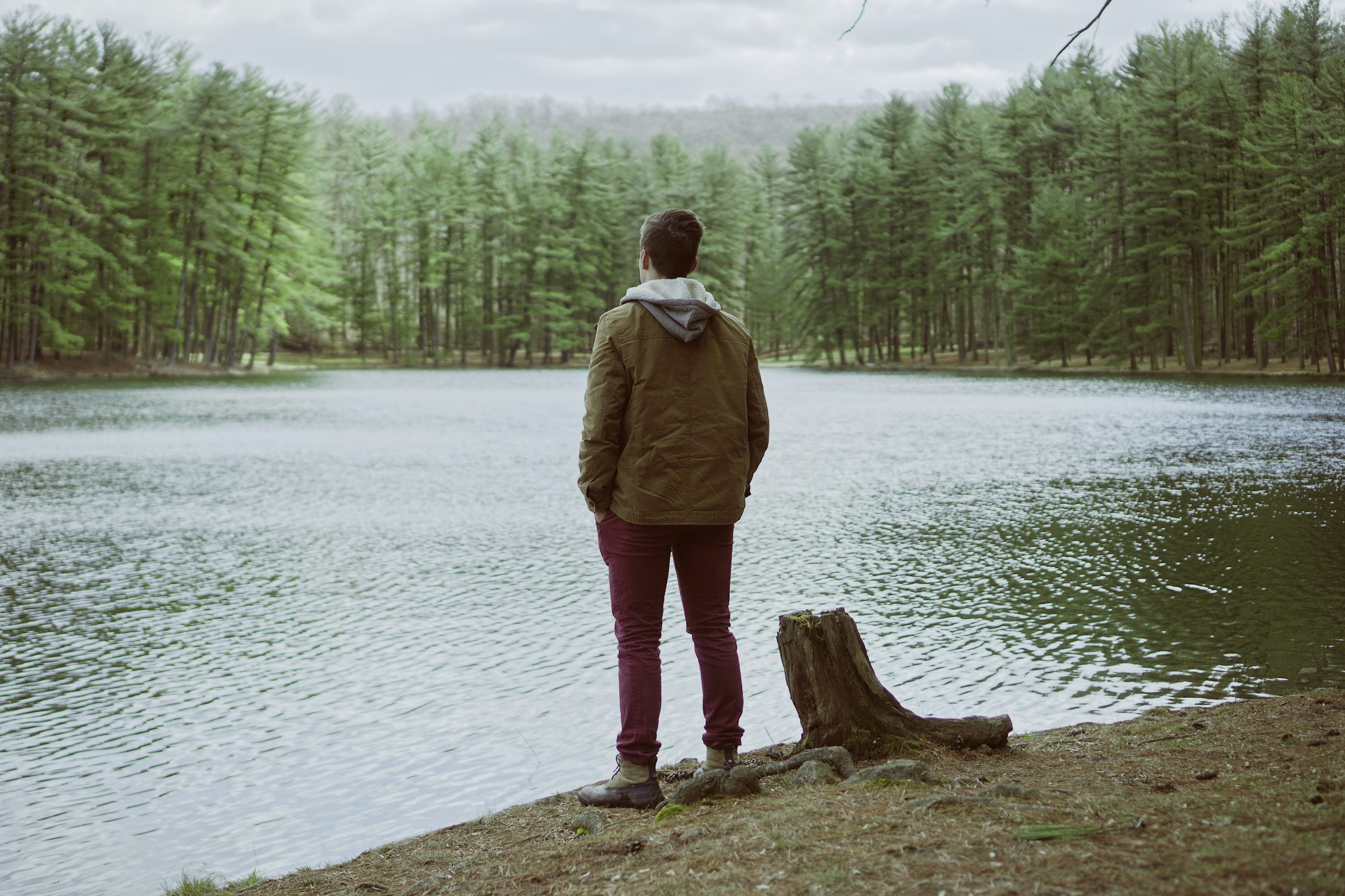 man standing near body of water