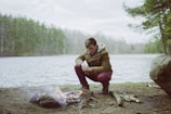 a man sitting next to a campfire Empowering young men through mental health retreats