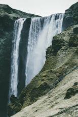 waterfalls near rock mountain