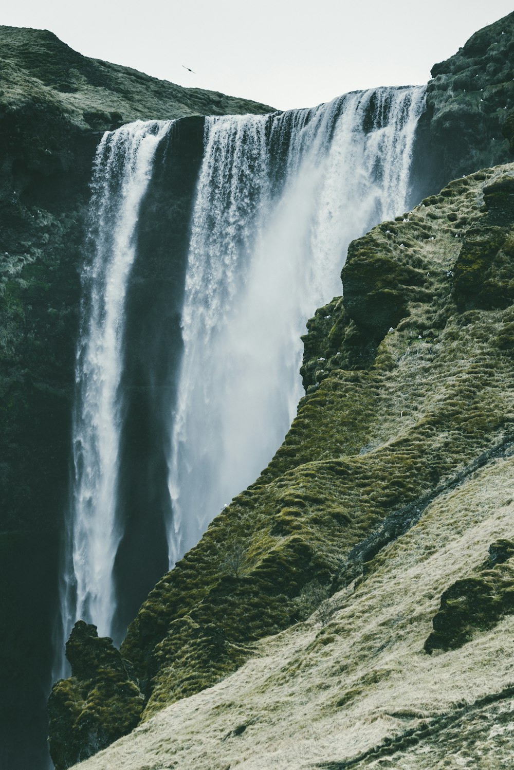 waterfalls near rock mountain