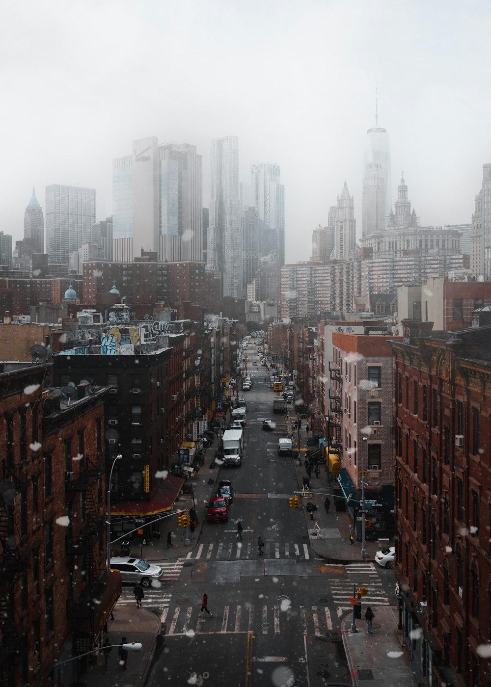 cars parked between buildings under cloudy sky at daytime