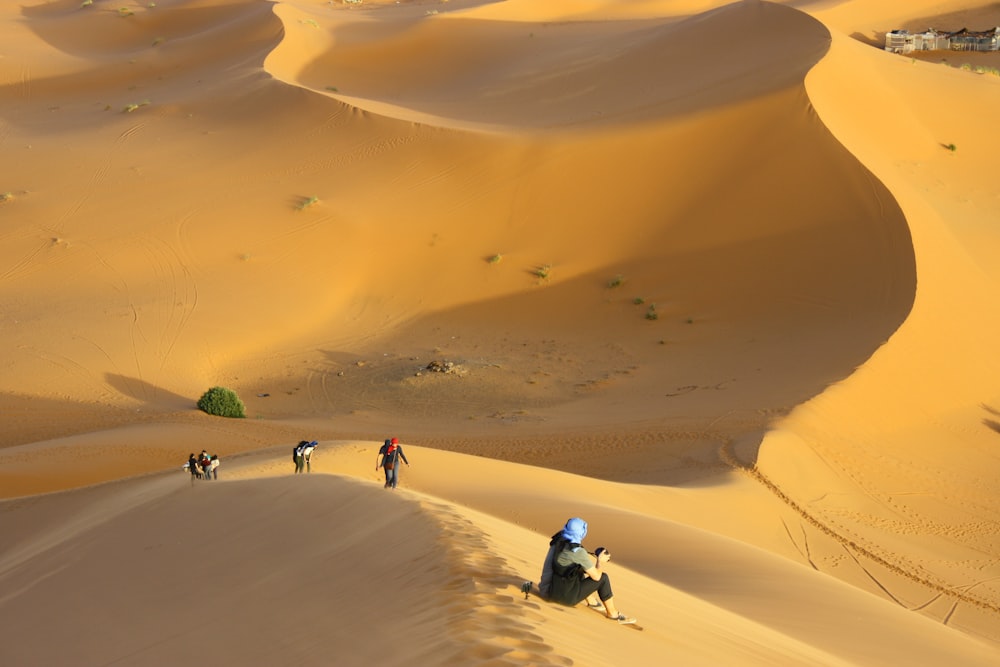 group of people standing on desert