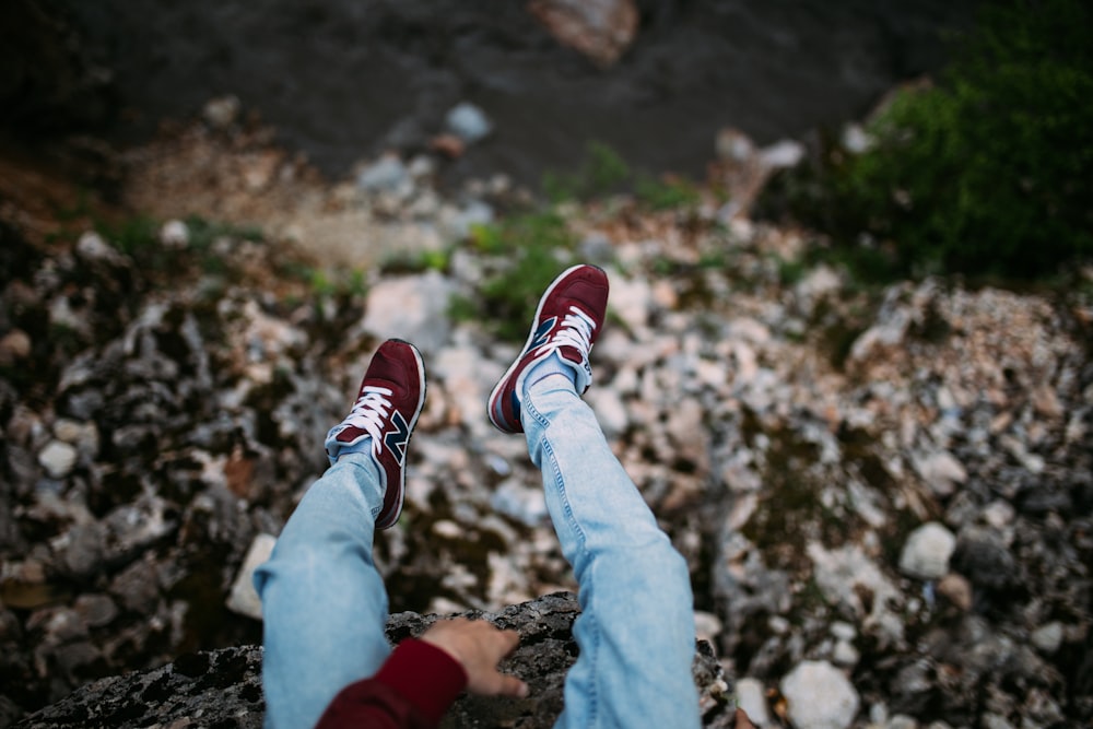 person sitting on cliff