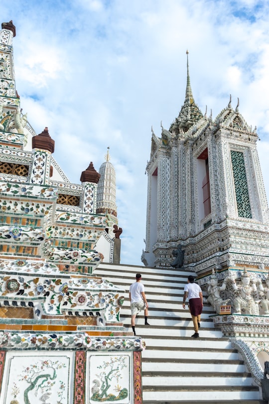 two person on white stairs in Wat Arun Ratchawararam Ratchawaramahawihan Thailand