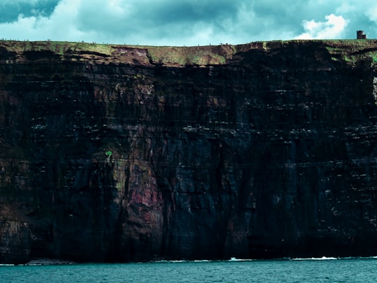 canyon during daytime in Cliffs of Moher Ireland