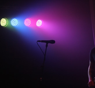 man playing guitar in front of microphone