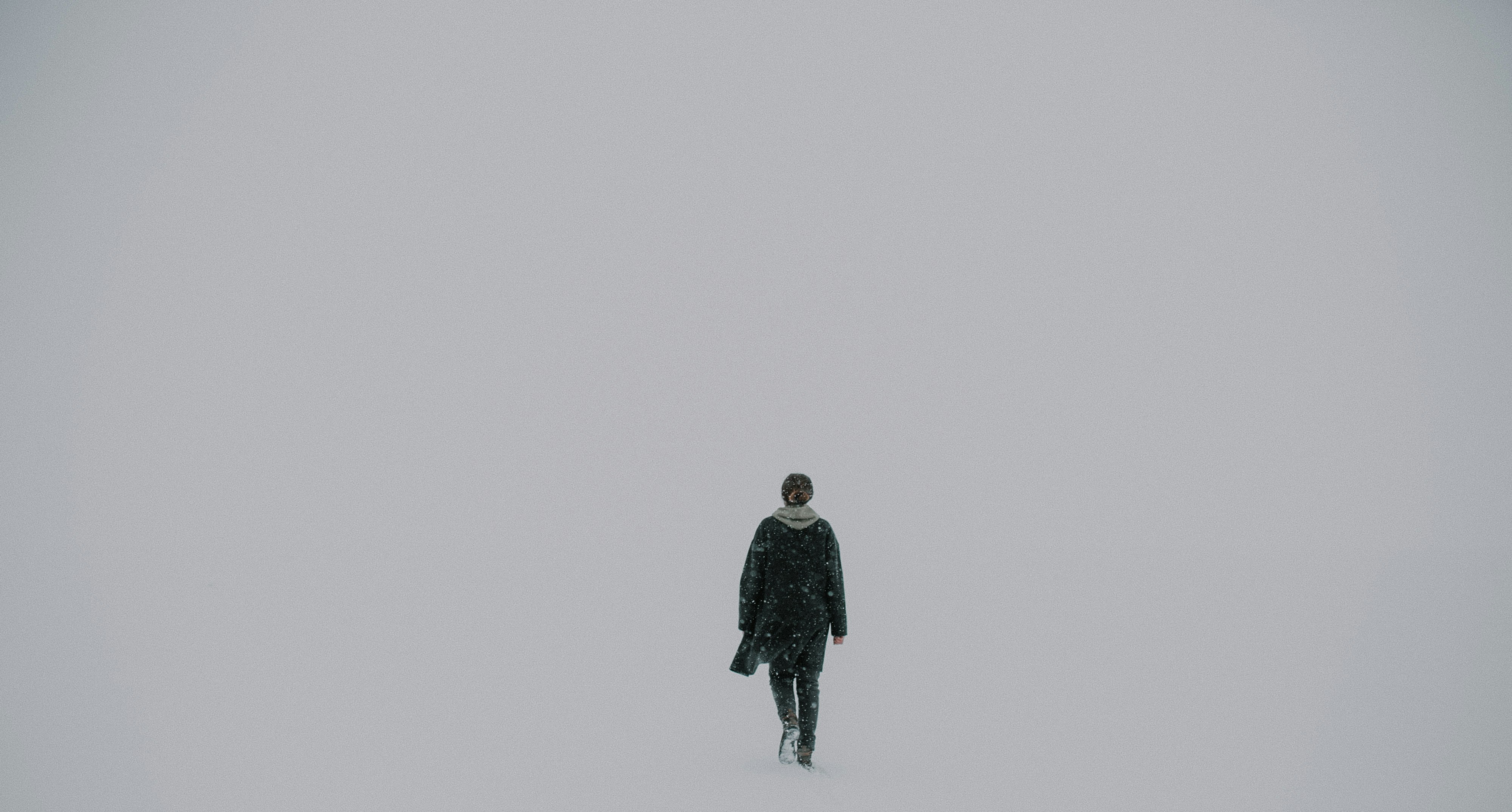 man walking on white surface