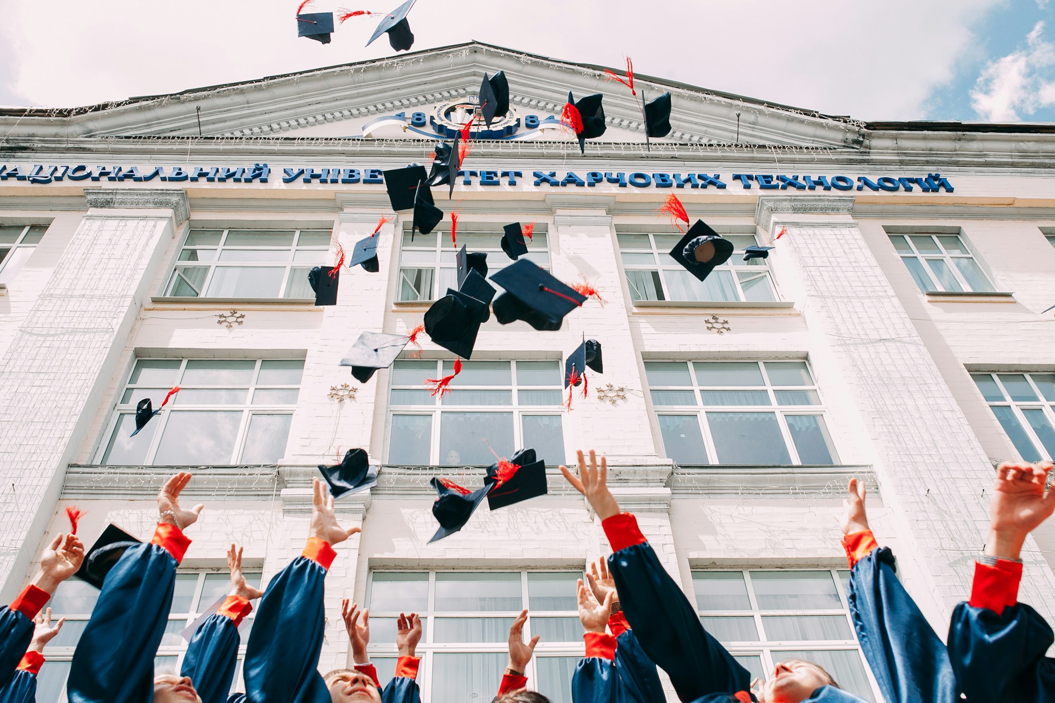 Graduating students throwing up their caps.