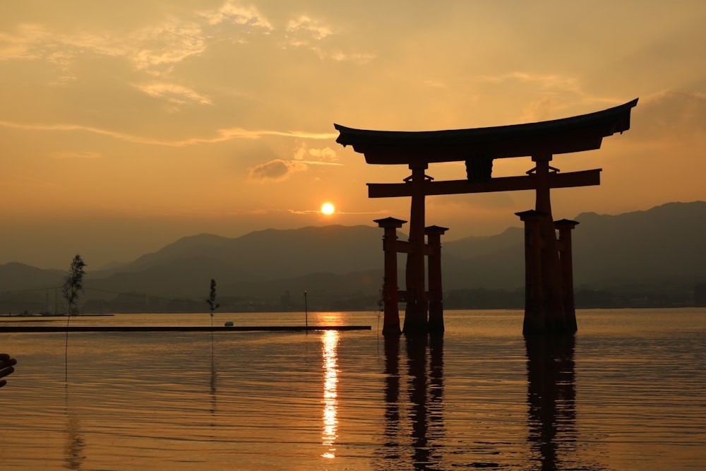 silhouette of arc surrounded by body of water