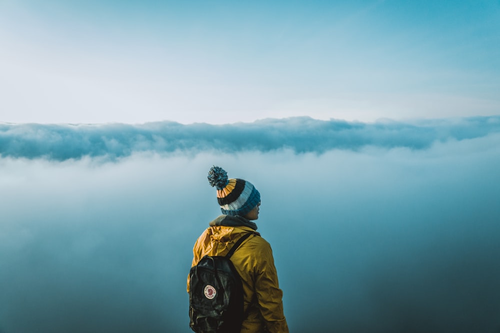 man standing on top of the mountain