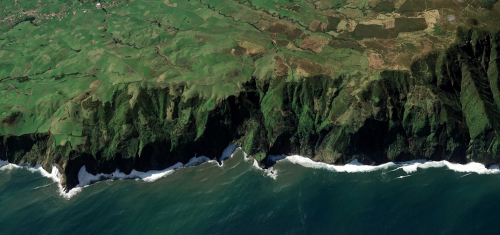 birds eye view of cliff near body of water