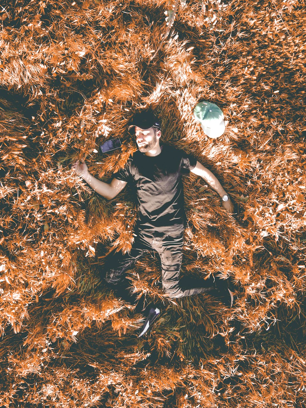 man lying on grass field