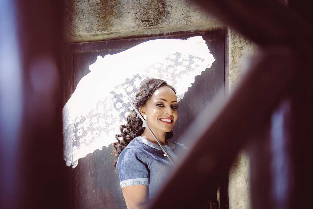 woman holding white umbrella