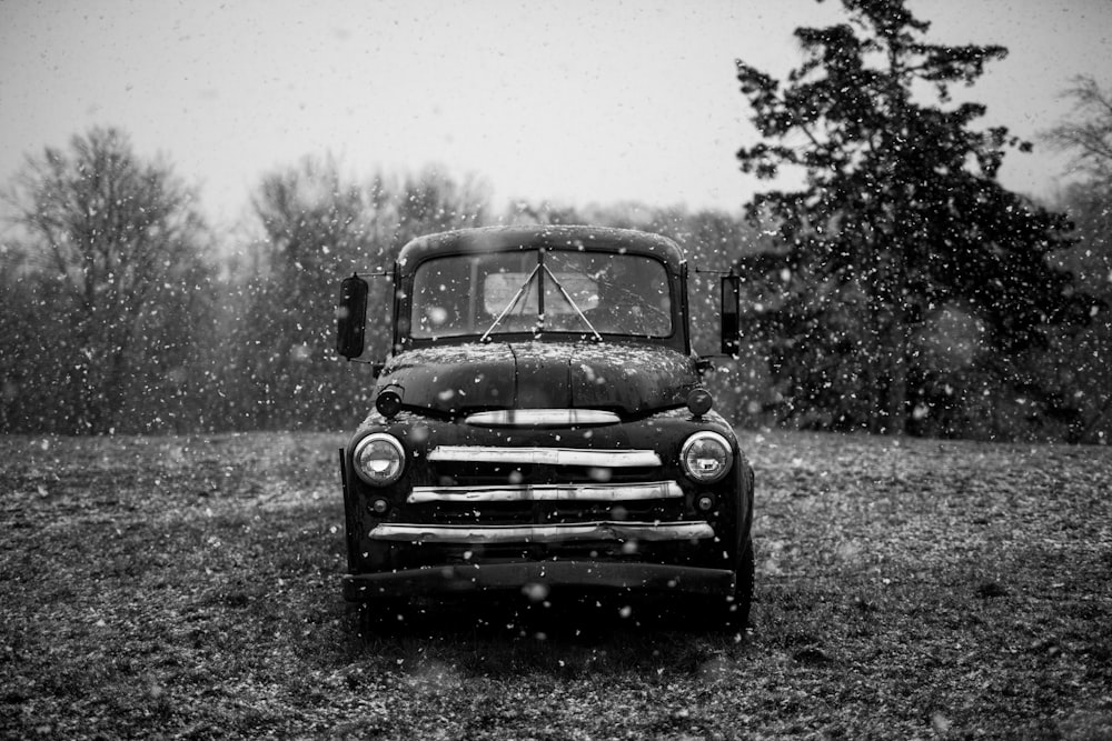 grayscale timelapse photography of classic vehicle on rainy season