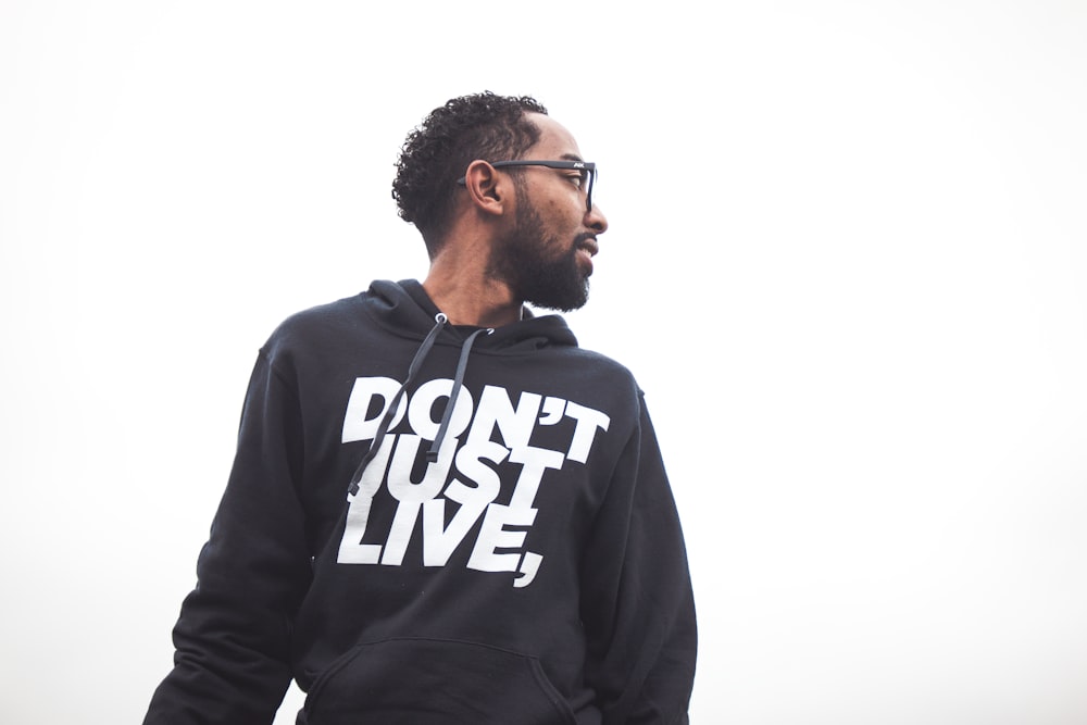 low angle photography of man wearing black hoodie