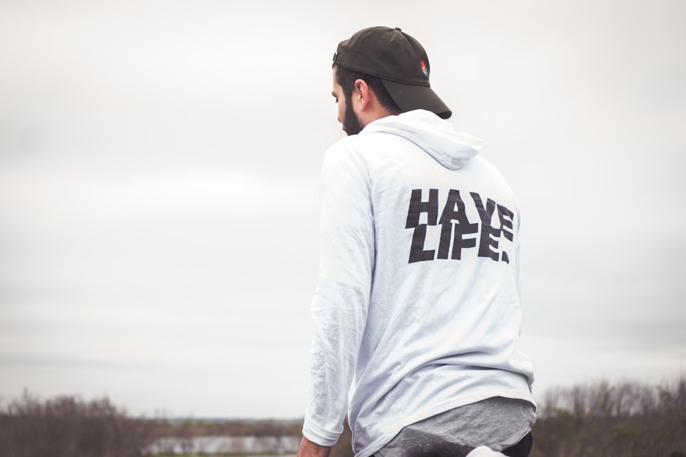 man in white and black hoodie and black cap