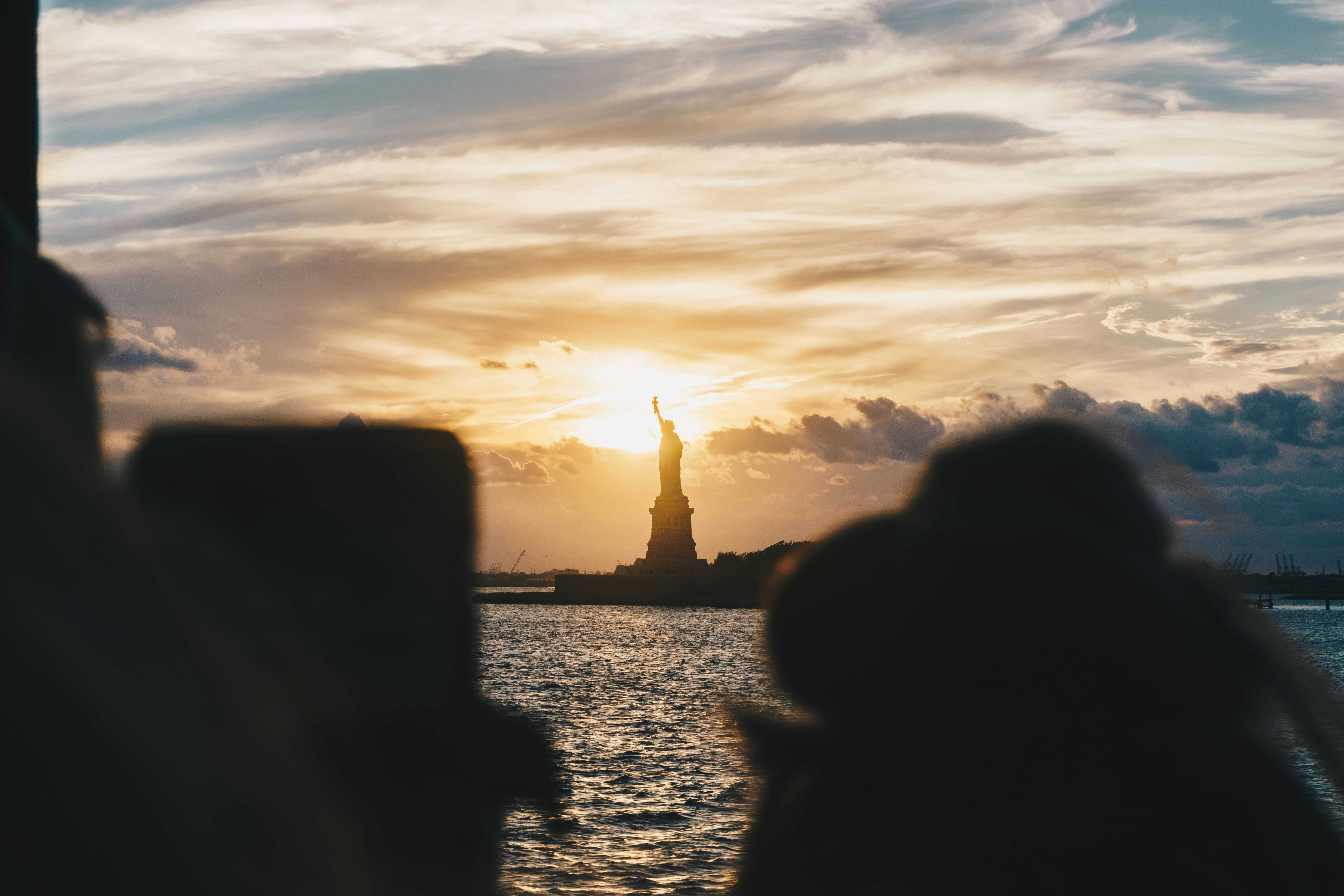 silhouette of Statue of Liberty, New York during golden hour
