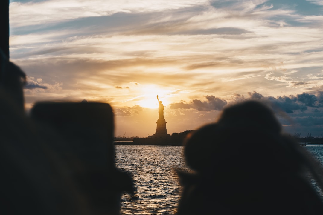 silhouette of Statue of Liberty, New York during golden hour