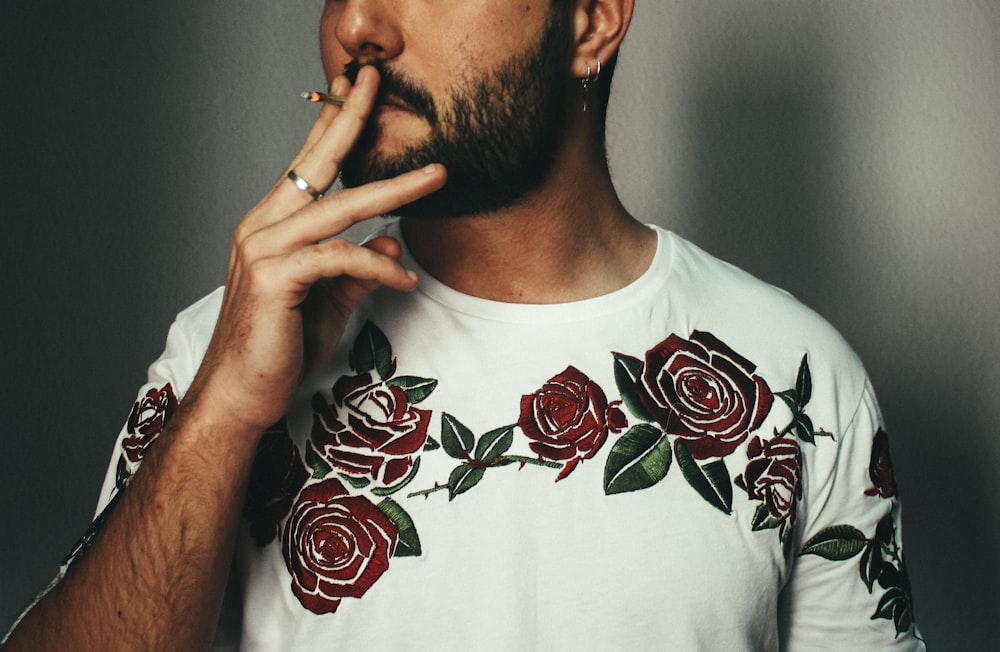 man smoking cigarette near wall