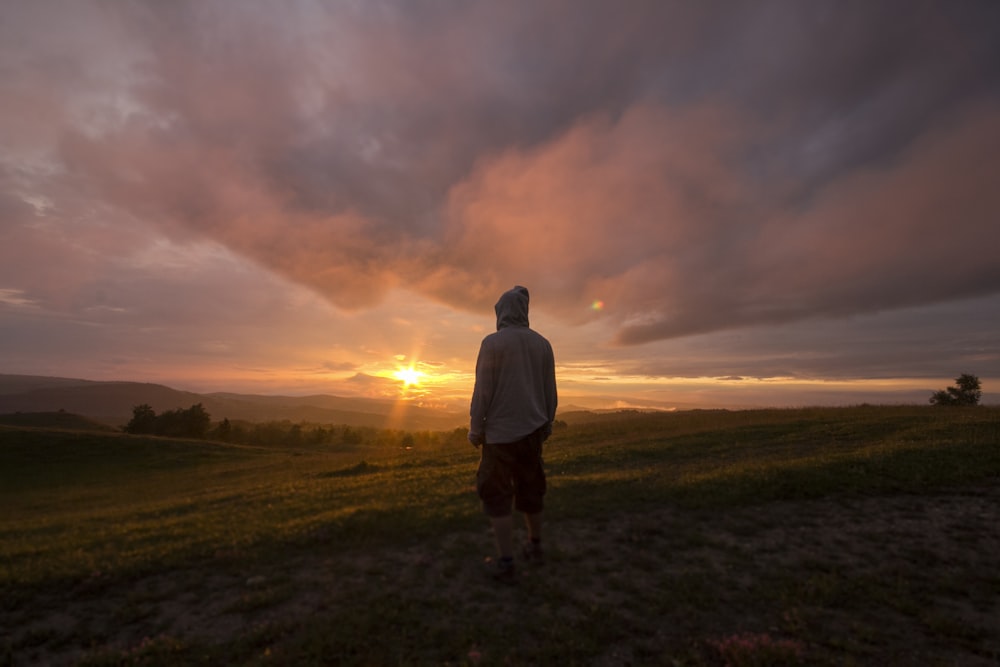 person standing in front of sunset