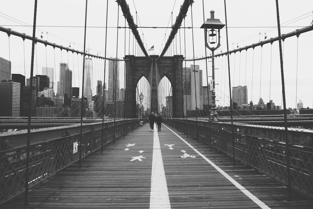 person walking on Brooklyn Bridge