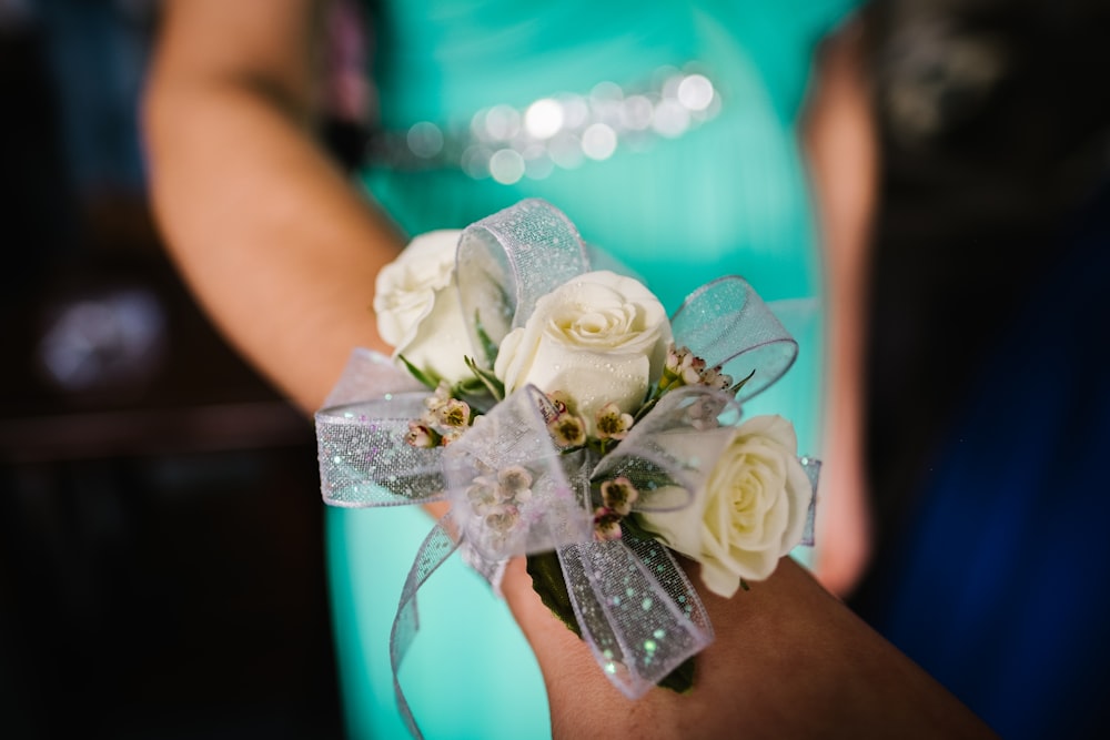 selective focus photography of woman's wrist wearing corsafge