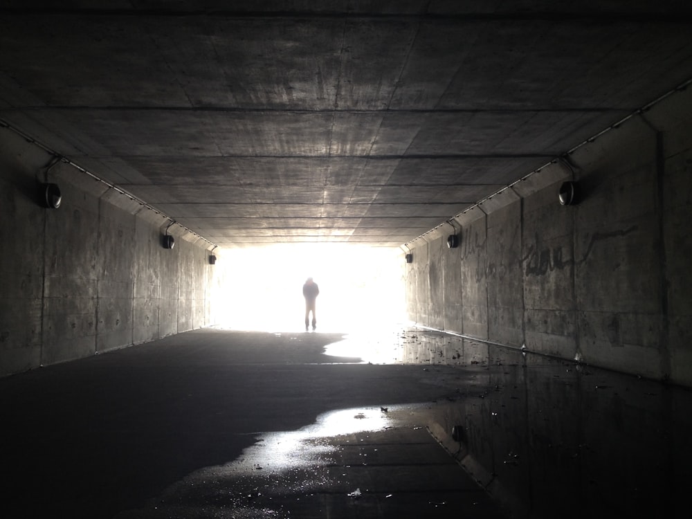 person walking in tunnel