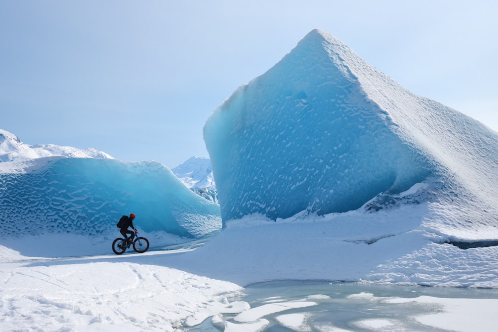 person riding bicycle throught ice ridges