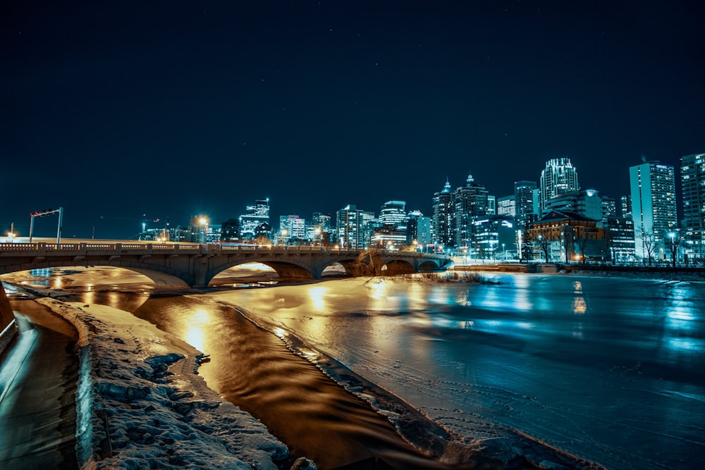 lighted bridge beside buildings