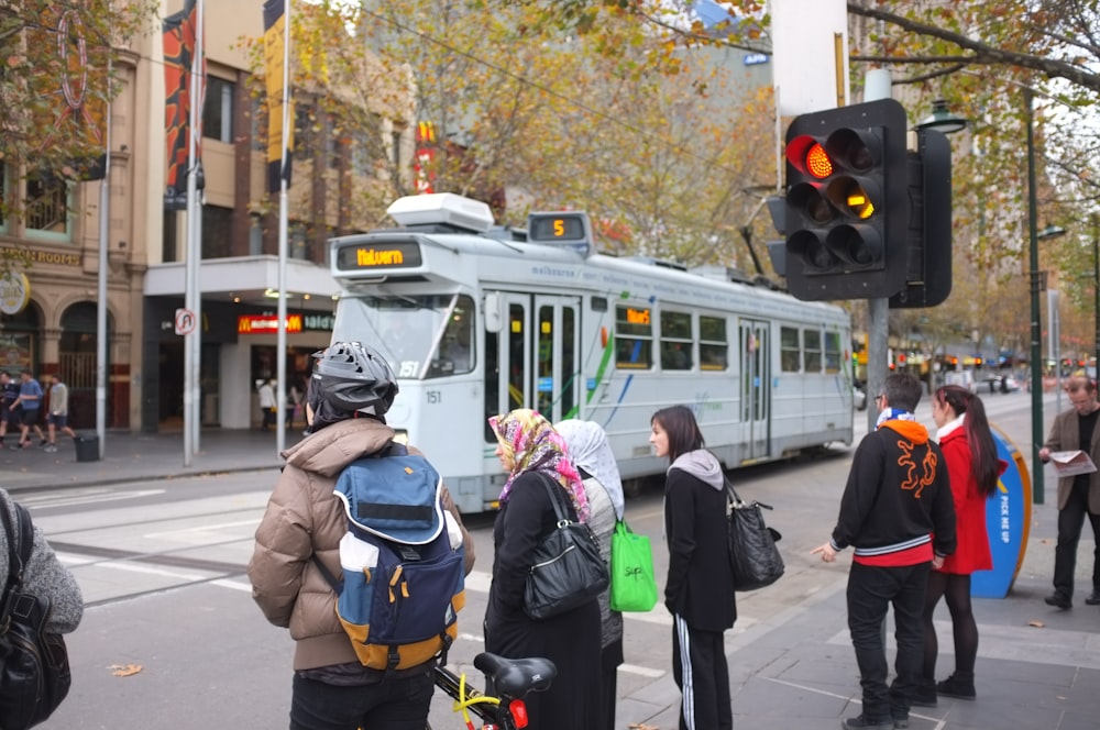 people standing near traffic lights