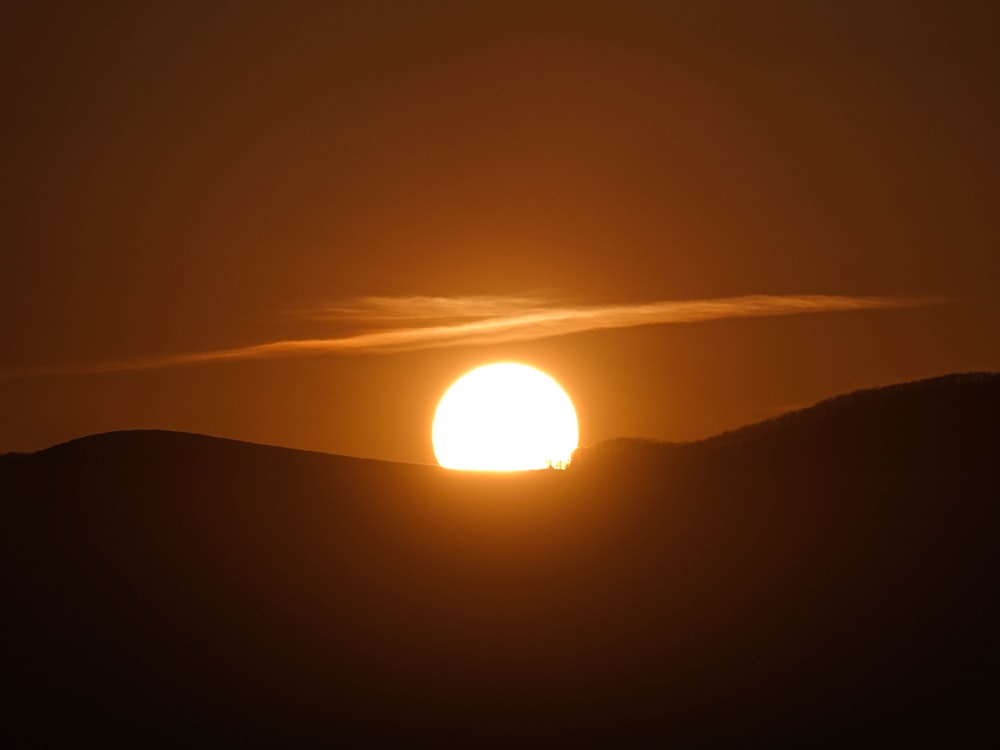 silhouette of mountain under sun