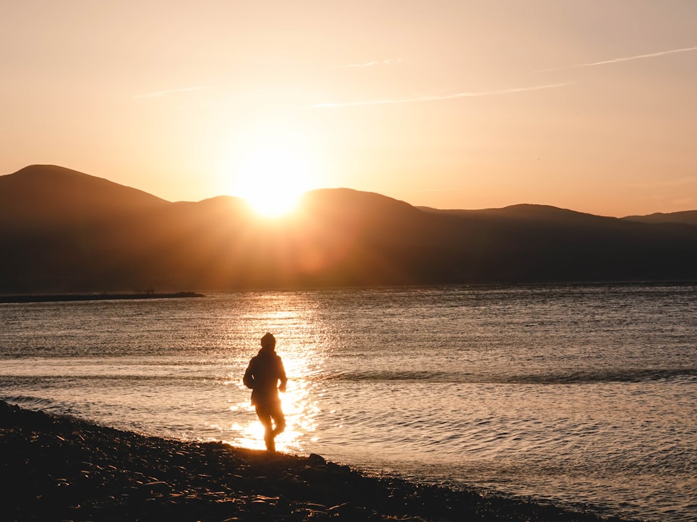 person standing near sea shore