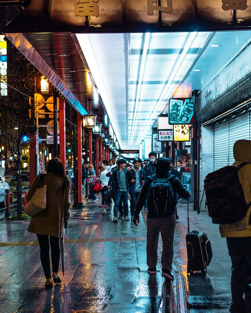 man holding luggage bag while walking