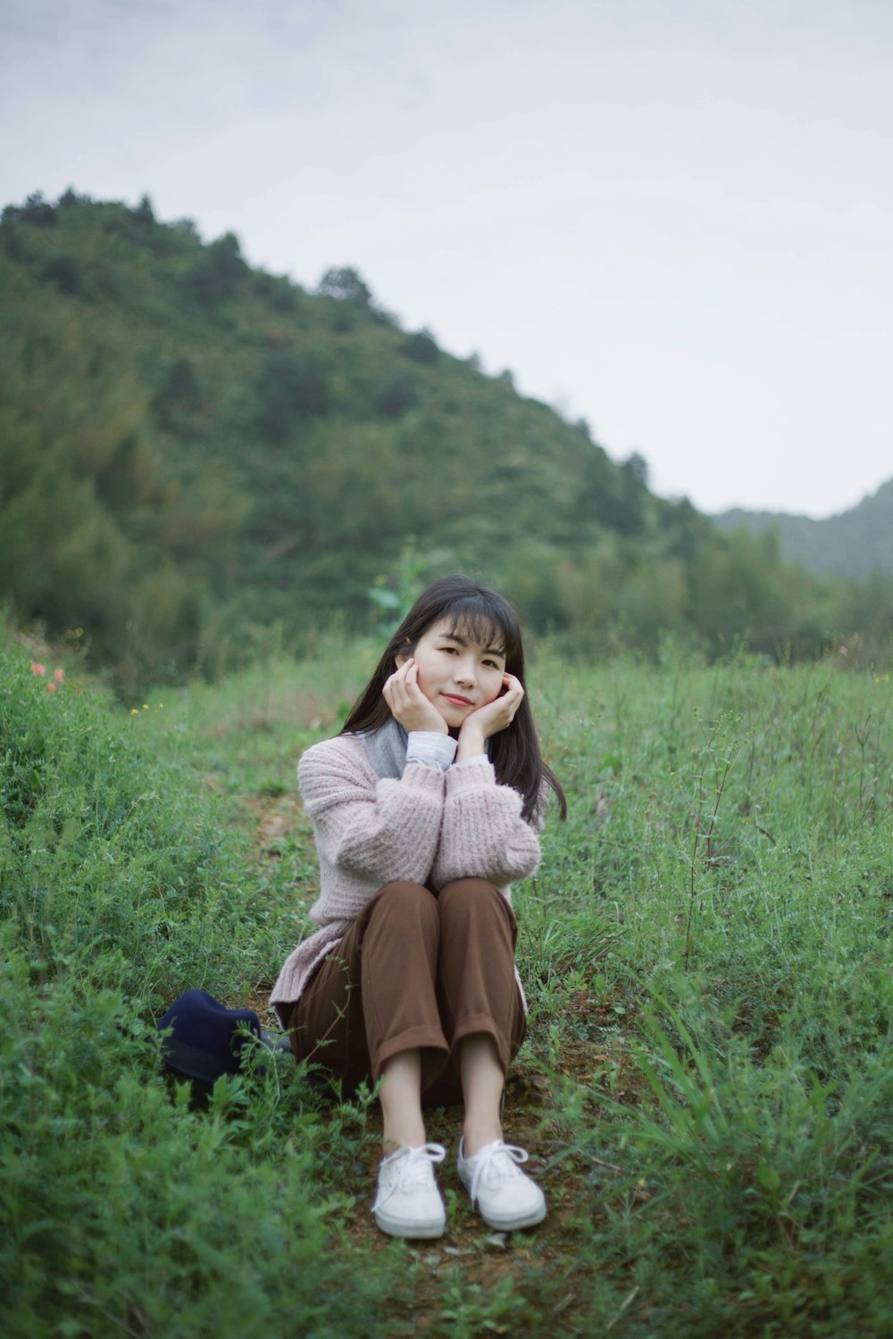 woman sitting on green grass