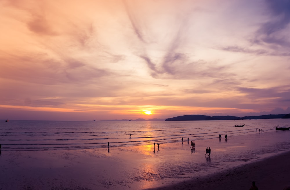 aerial view of people on shoreline during sunset