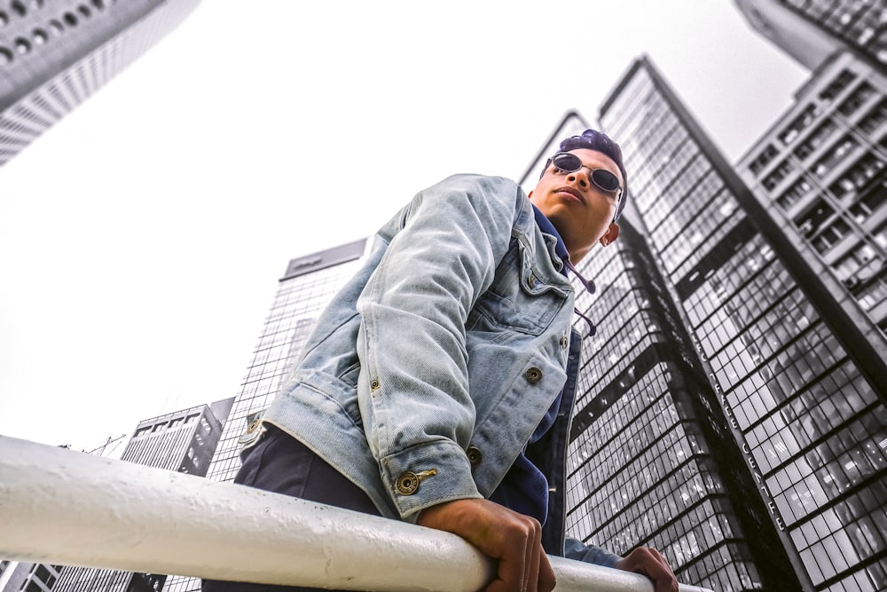 man standing near white steel post