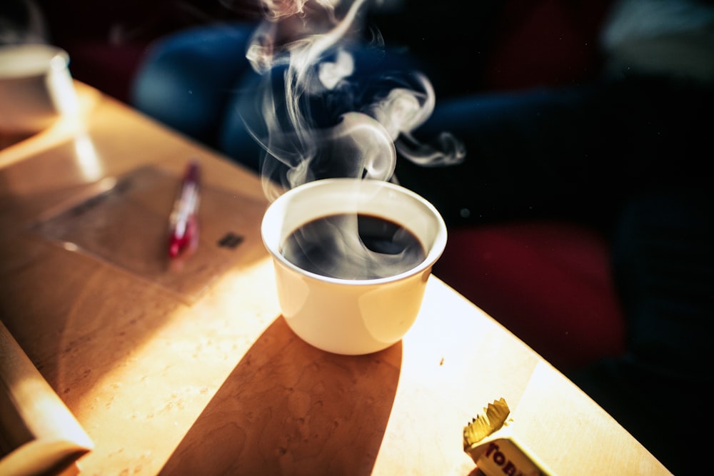 white coffee cup on table