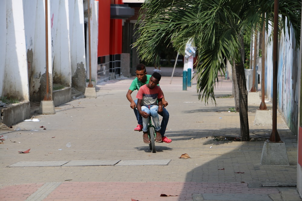 two men riding bicycle during daytime