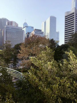 Cityscape showing a mix of green spaces and contemporary buildings.