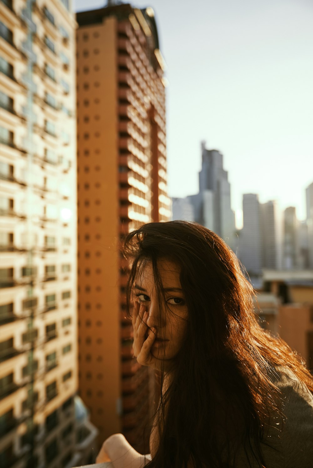 donna in parte superiore grigia accanto all'edificio