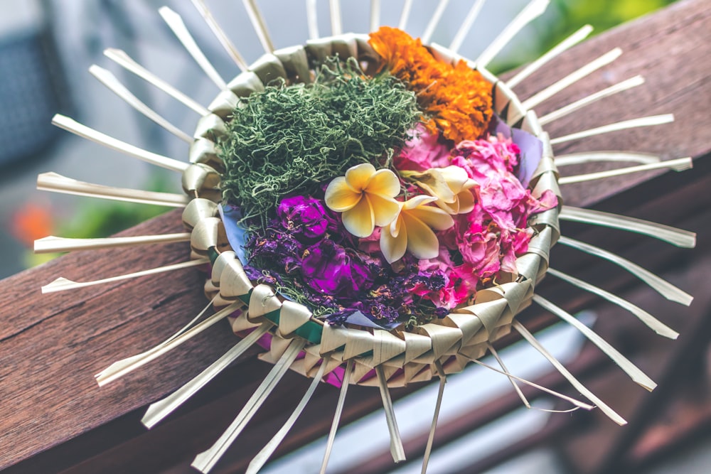 assorted-color petaled flower on paper basket