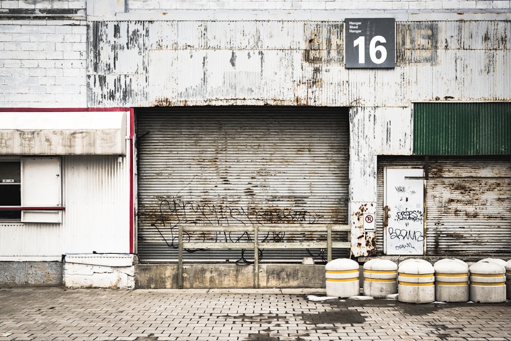 closed gray roll-up doors below 16 signage