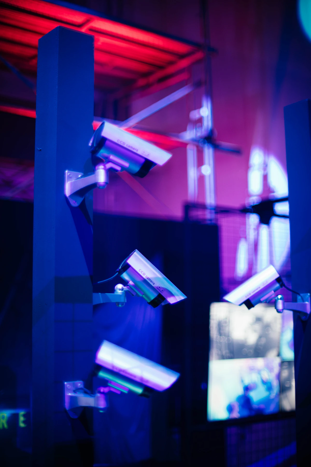 Tech monitoring station with live camera feeds showing all active escape rooms