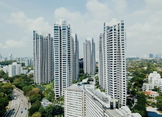 white high rise buildings under white clouds