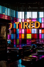 vacant chair and table inside multicolored glass wall