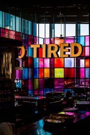 vacant chair and table inside multicolored glass wall