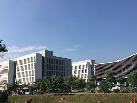 A panoramic view of a modern technology park with sleek office buildings surrounded by green spaces and wide walkways.